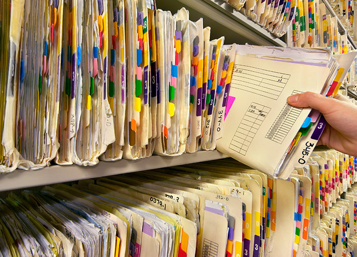 solutions__0004_man-removing-file-from-shelf-close-up-200410231-001-582f47c53df78c6f6a07c18d